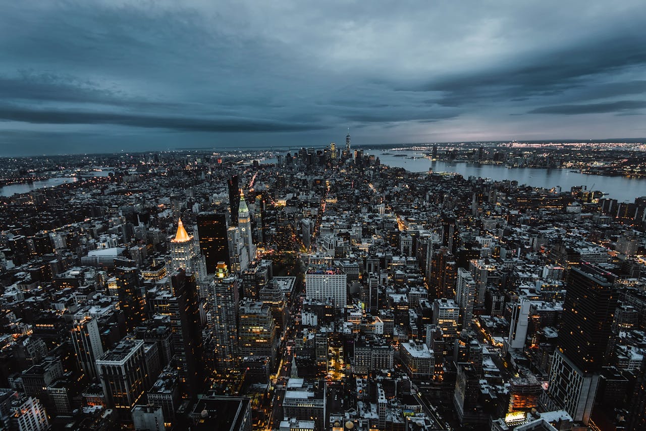 services-03 Stunning aerial view of New York City's skyscrapers and skyline at dusk, showcasing the urban landscape.