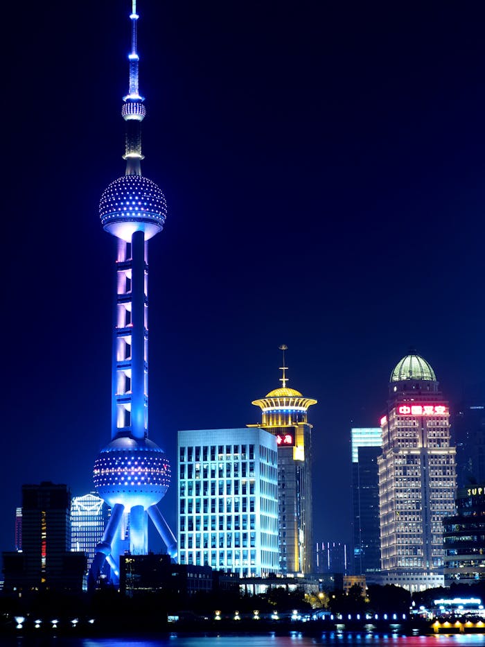 services-01 Breathtaking view of Shanghai's illuminated Pudong skyline featuring the Oriental Pearl Tower.